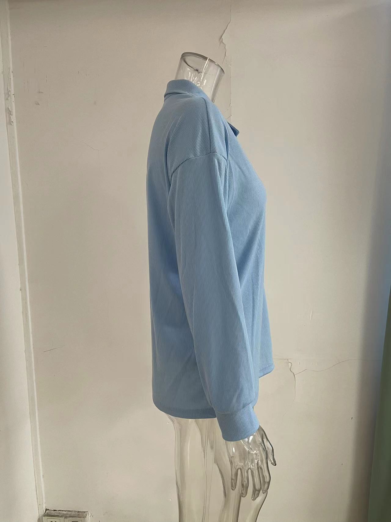 Women's loose fit long sleeve knit top in white – button detail front view