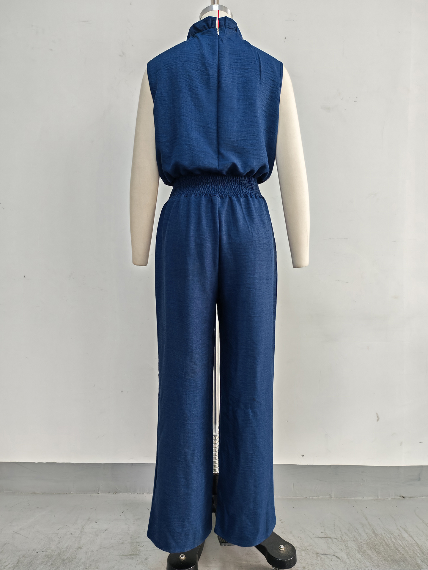 Women's wide-leg pleated jumpsuit in khaki, full length view showing high waist and wide-leg silhouette