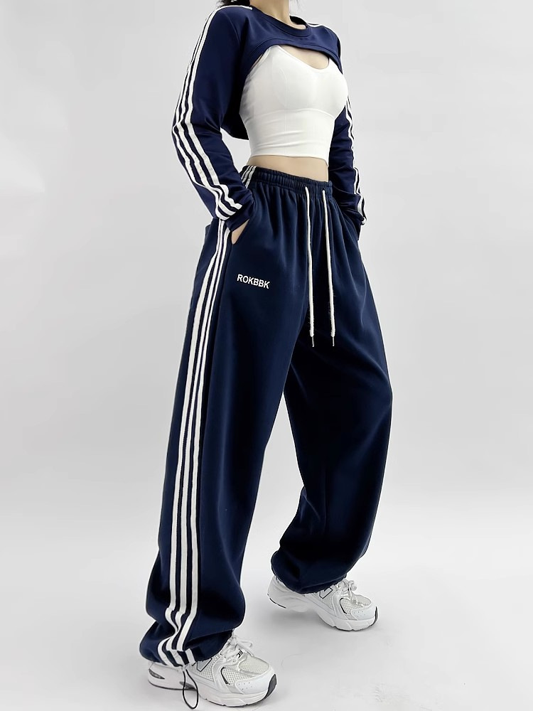Wide-leg athletic sweatpants, model wearing complete outfit styling photo