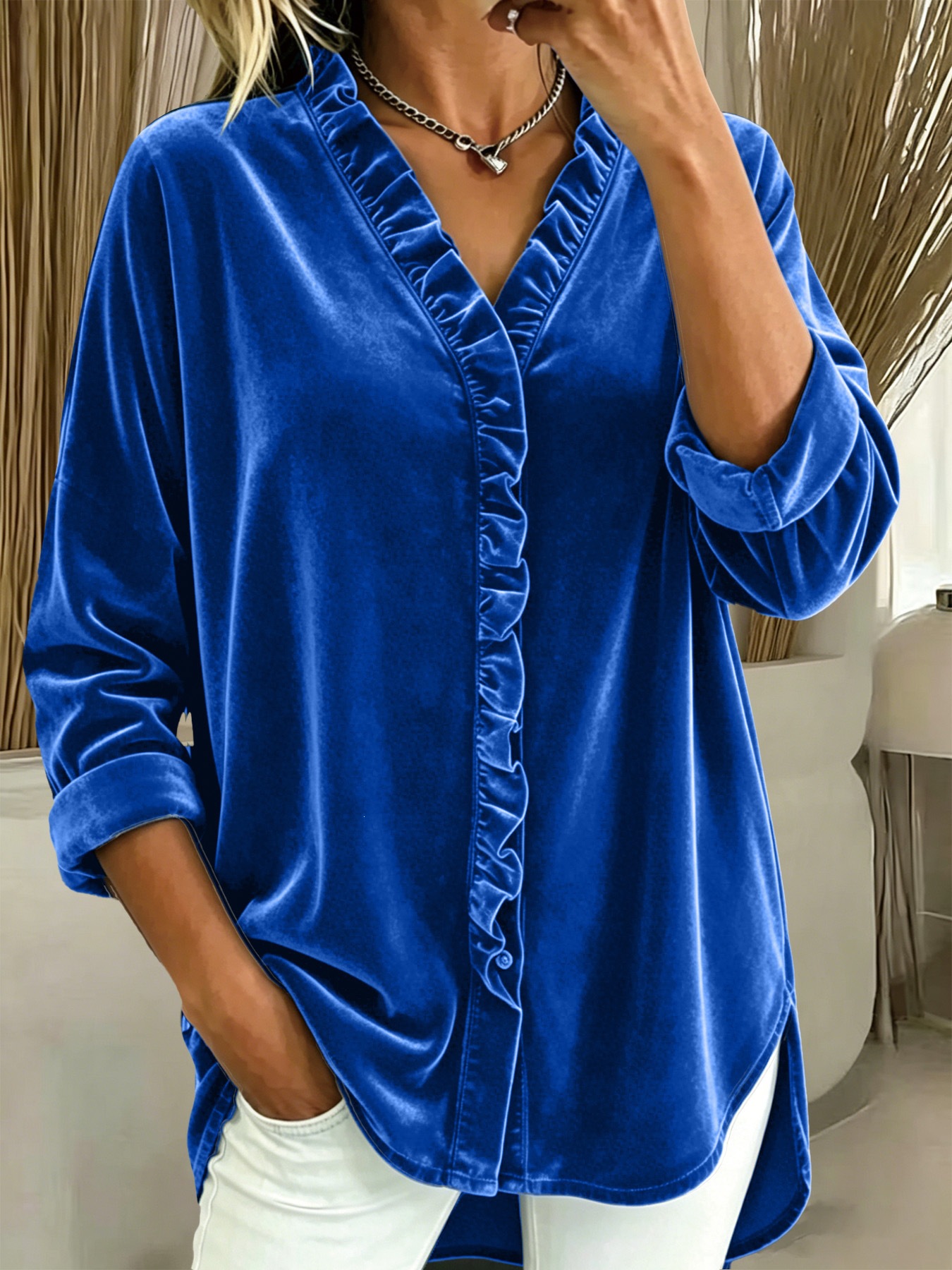 Women's velvet ruffle blouse detail — V-neck ruffled trim close-up