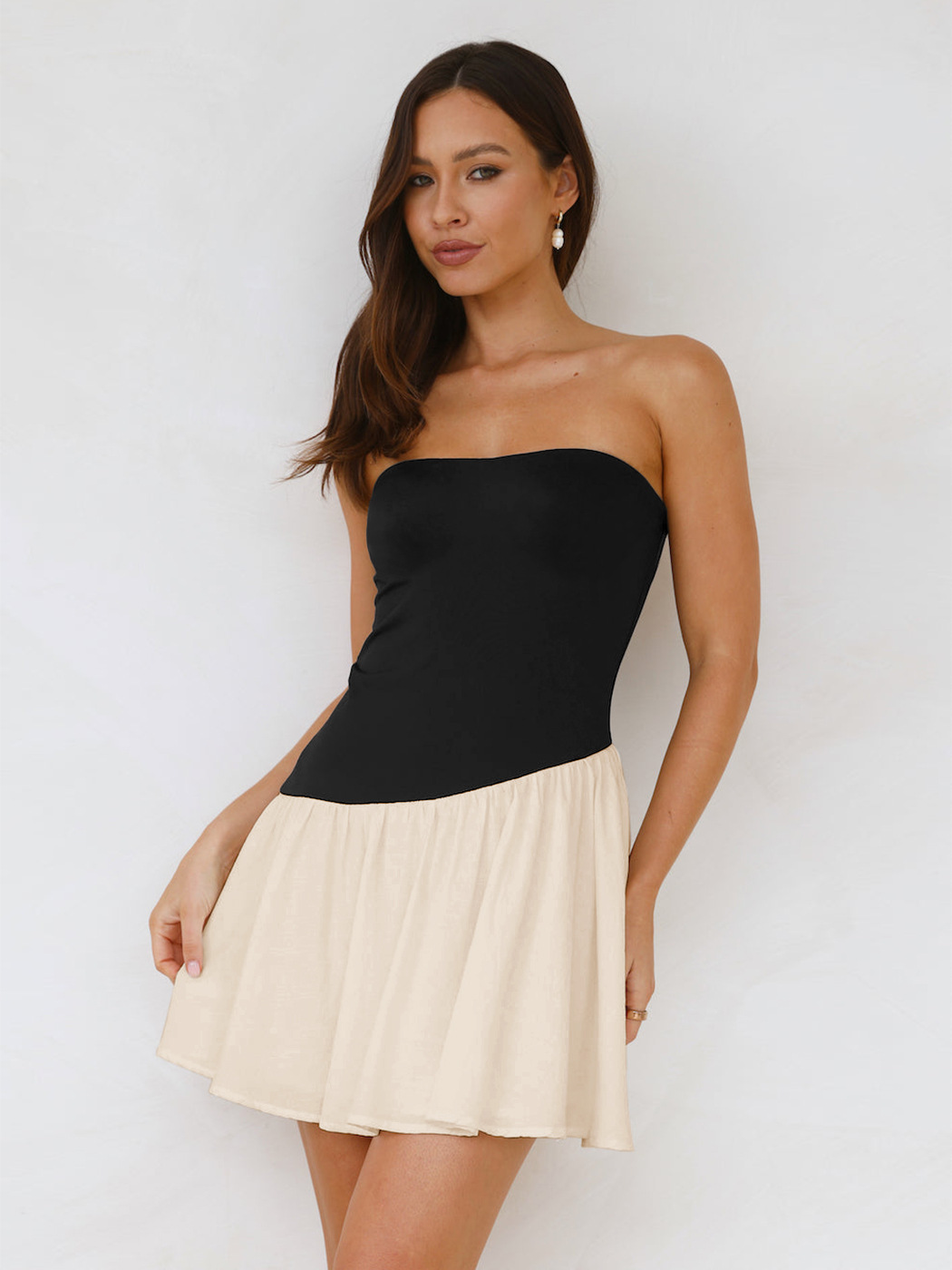 Women's pleated tube top dress in black, full outfit lifestyle photo showing slim fit