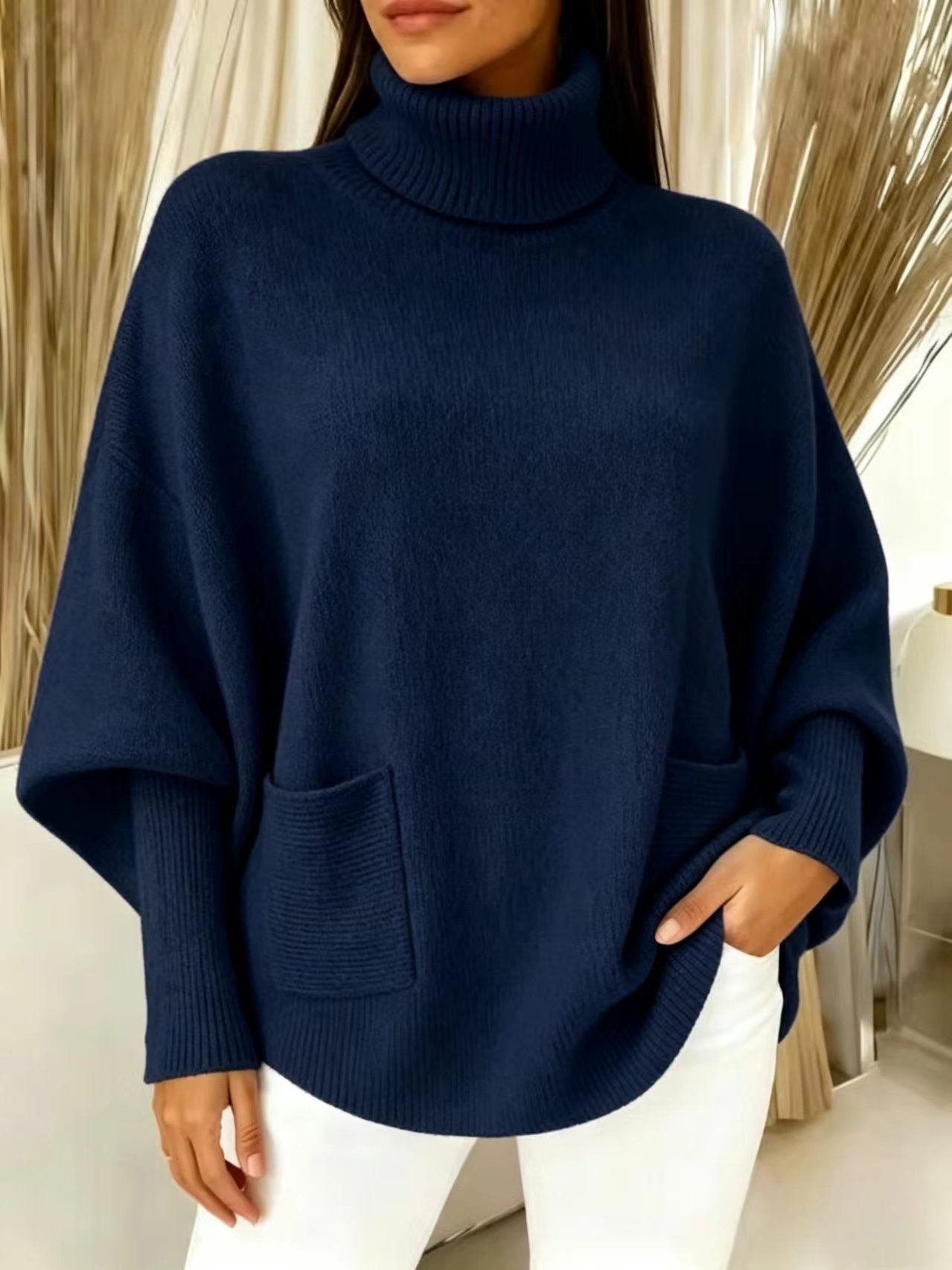 Women's oversized turtleneck sweater – styled on model showing full batwing sleeve silhouette and outfit