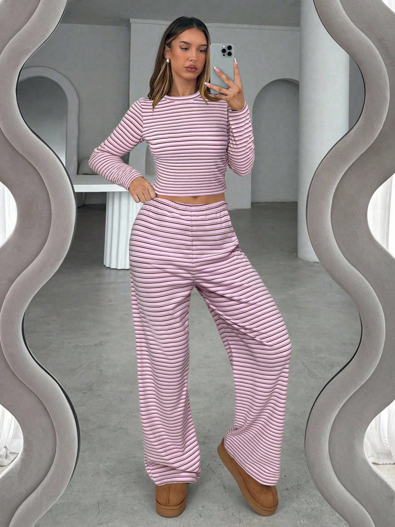 Women's striped long-sleeve top and wide-leg pants outfit detail