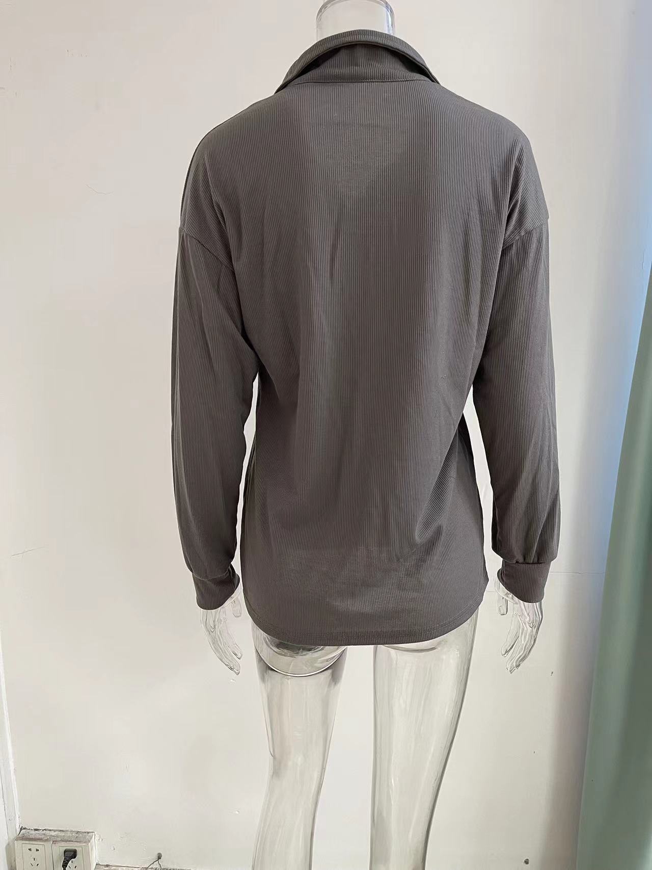Women's loose fit long sleeve top – fabric and button detail close-up