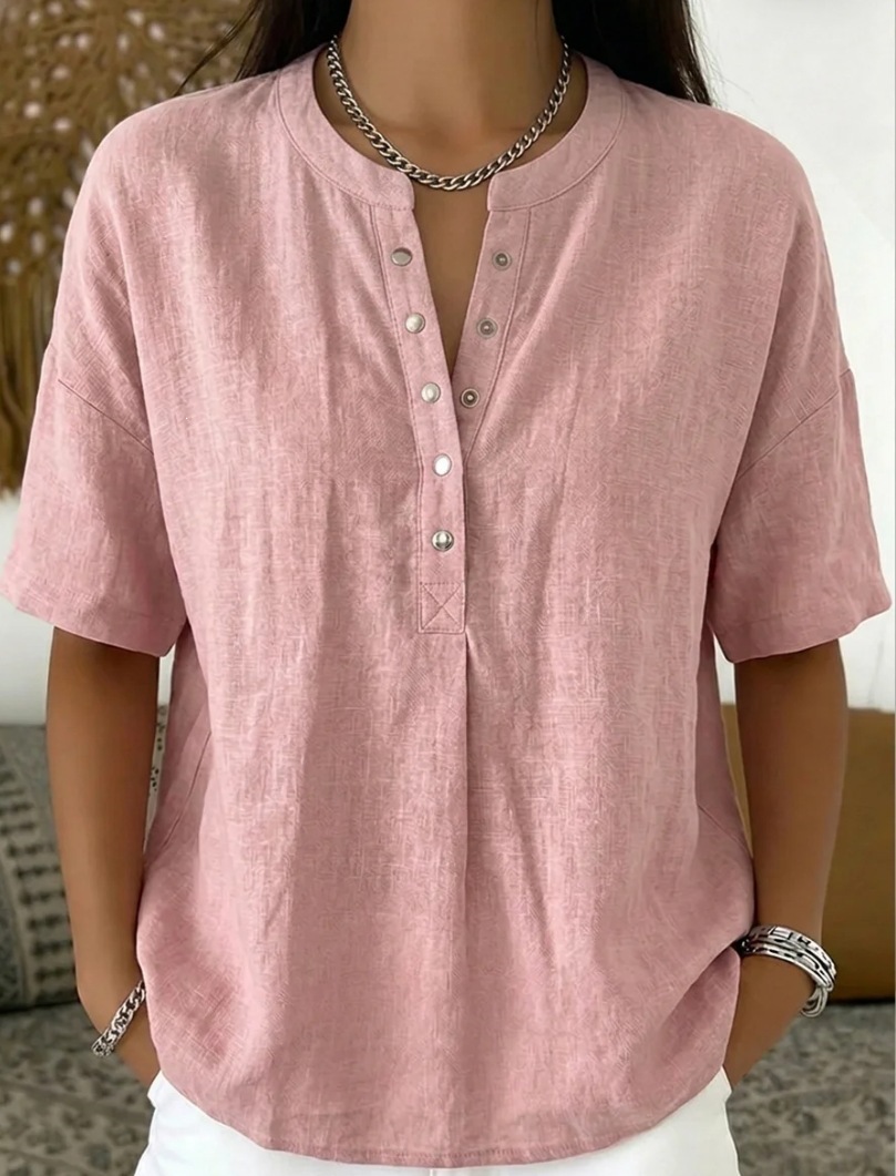 Women's solid color short-sleeve top in green, casual lifestyle photo showing loose fit