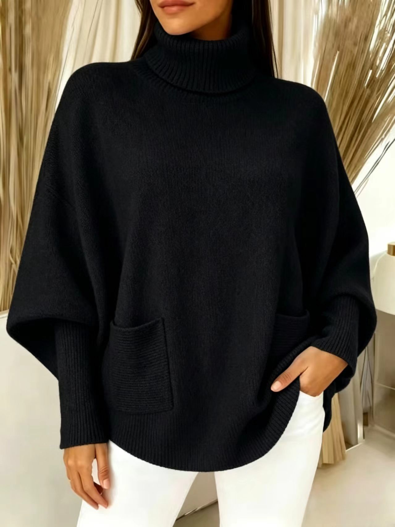 Women's knit sweater – close-up of front patch pocket and curved hem detail