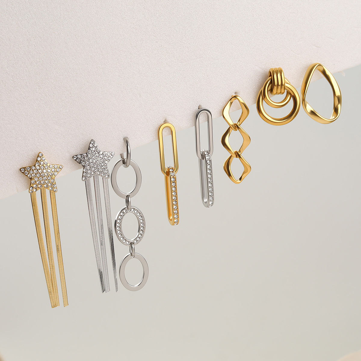 Stainless Steel Geometric Earrings With A Star-and-tassel Design Accented With Diamonds