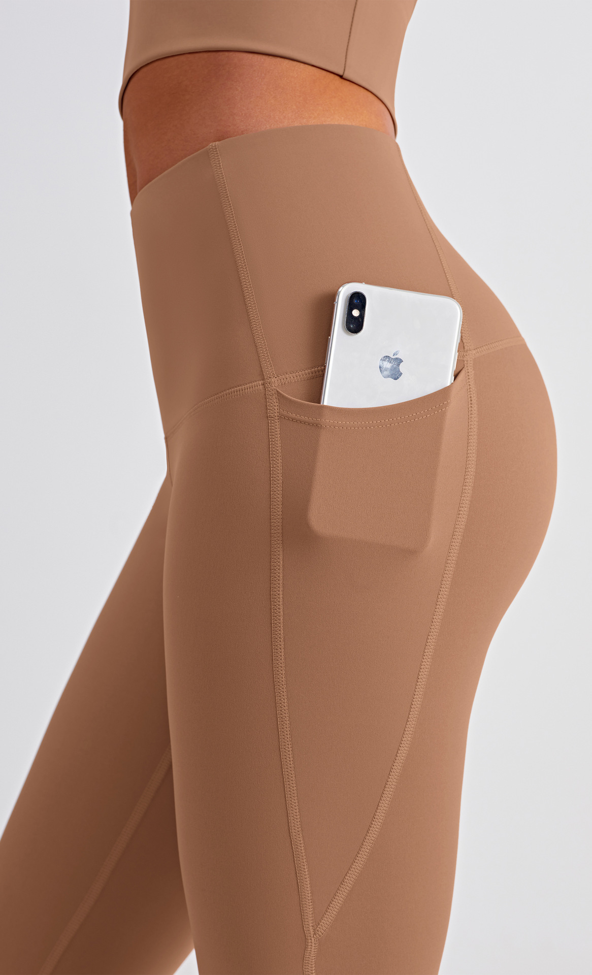 Women's fitness leggings showing high-waist design and pocket detail
