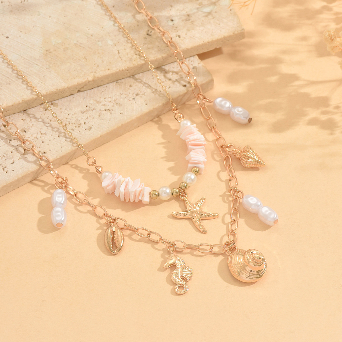 Resort style ocean pendant necklace on model
