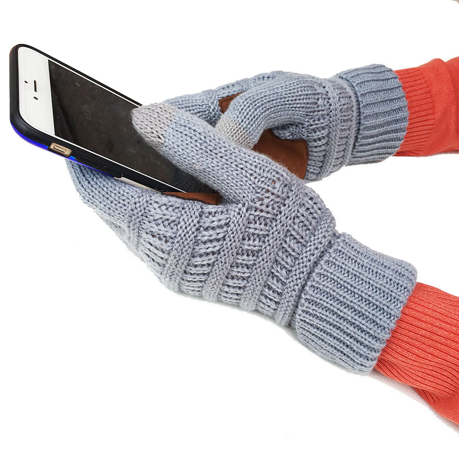 In a crisp winter setting, an individual wearing the European and American Wool Knitted Turn-over Labeling Touch Screen Gloves in gray effortlessly operates a smartphone while sporting an orange sleeve. The seamless interaction of the thumb and index finger with the touchscreen highlights the impressive touchscreen capabilities of these gloves against a white background.