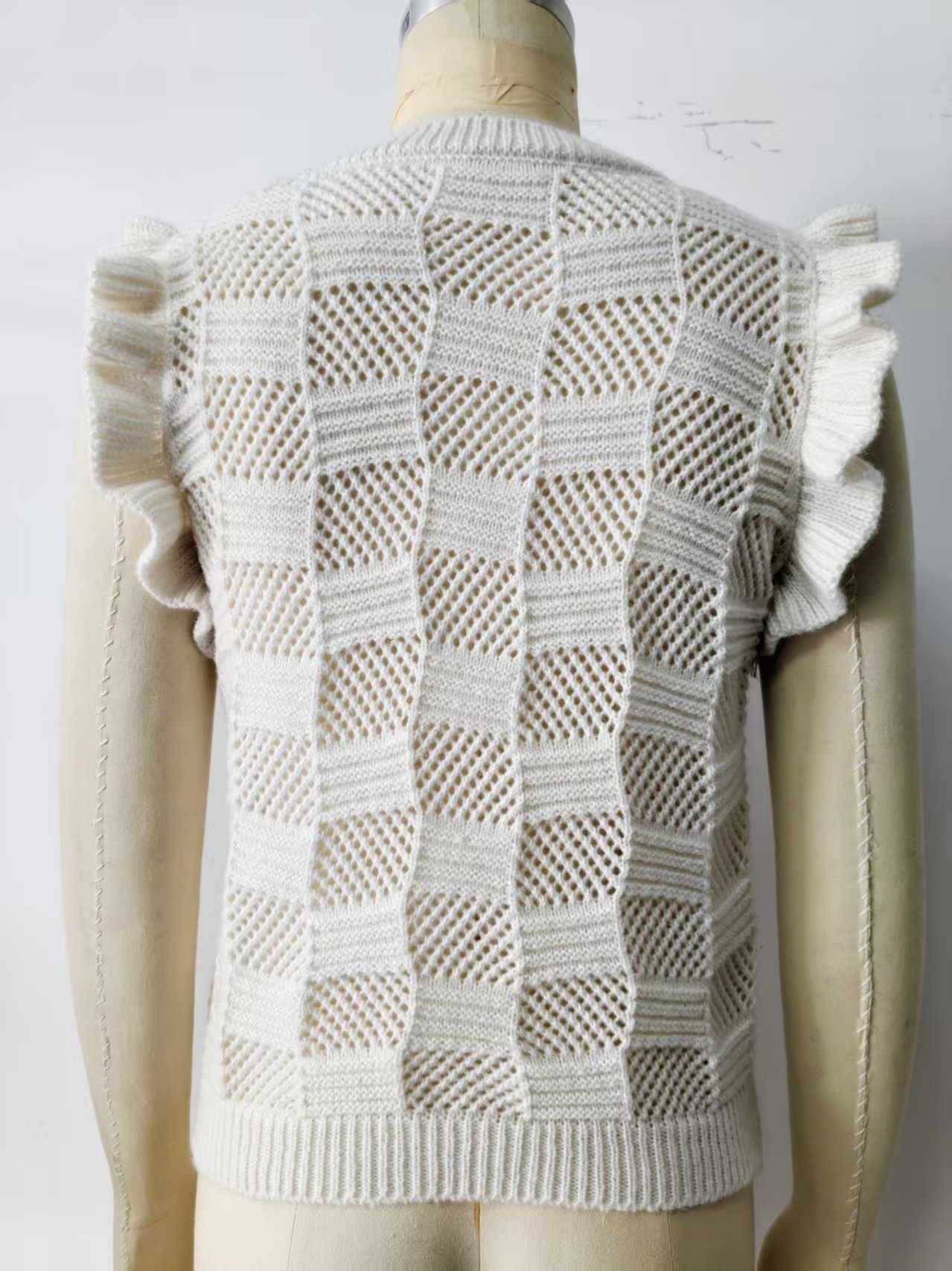Women's open-knit sleeveless vest styled as beach cover-up over bikini – boho vacation look